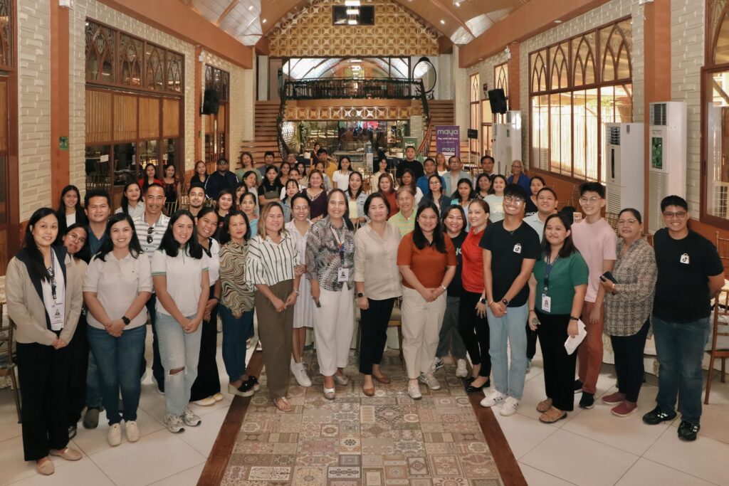 Over 70 participants pose with subject matter experts after the whole-day training event.